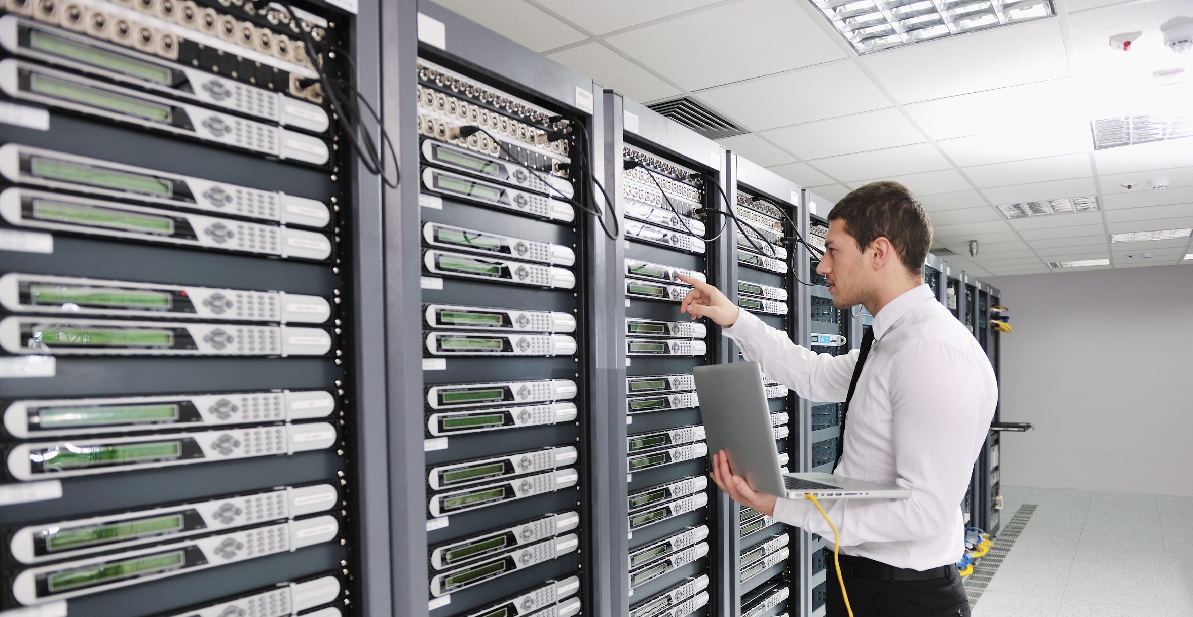 young engeneer in datacenter server room